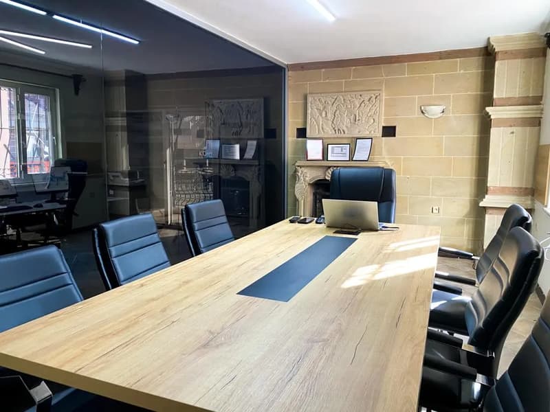 The meeting room at the Maxtoria office, with the company licences framed on the wall